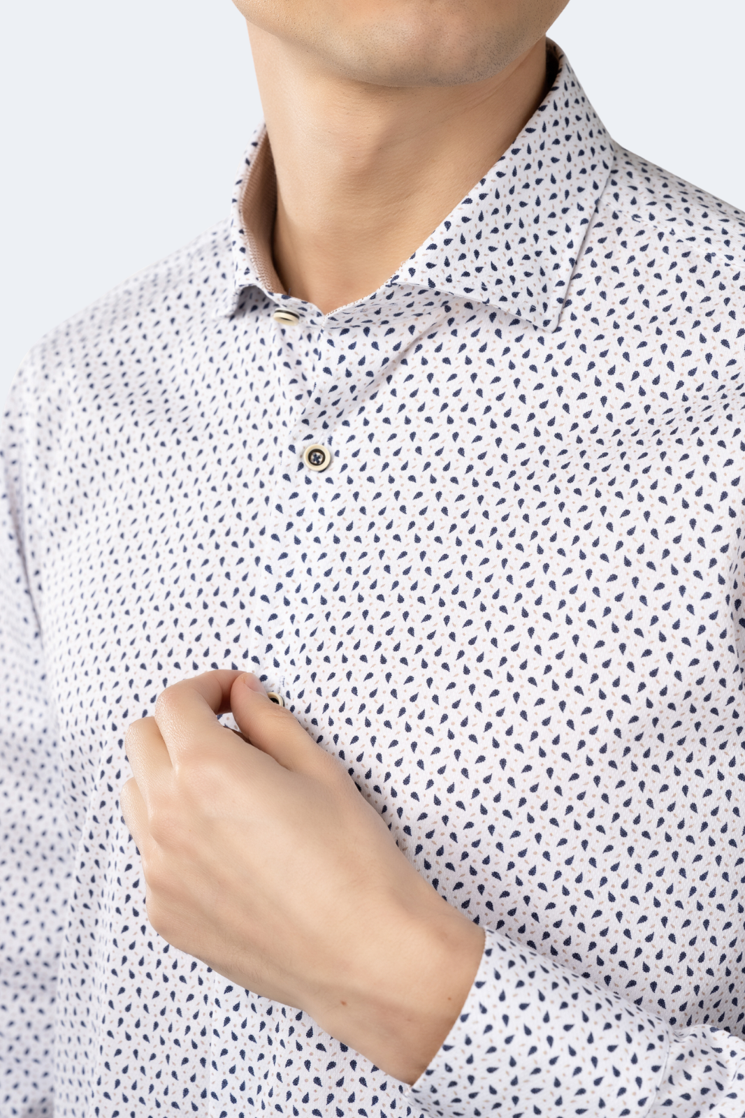 Close-up of a person wearing a white shirt with black geometric pattern