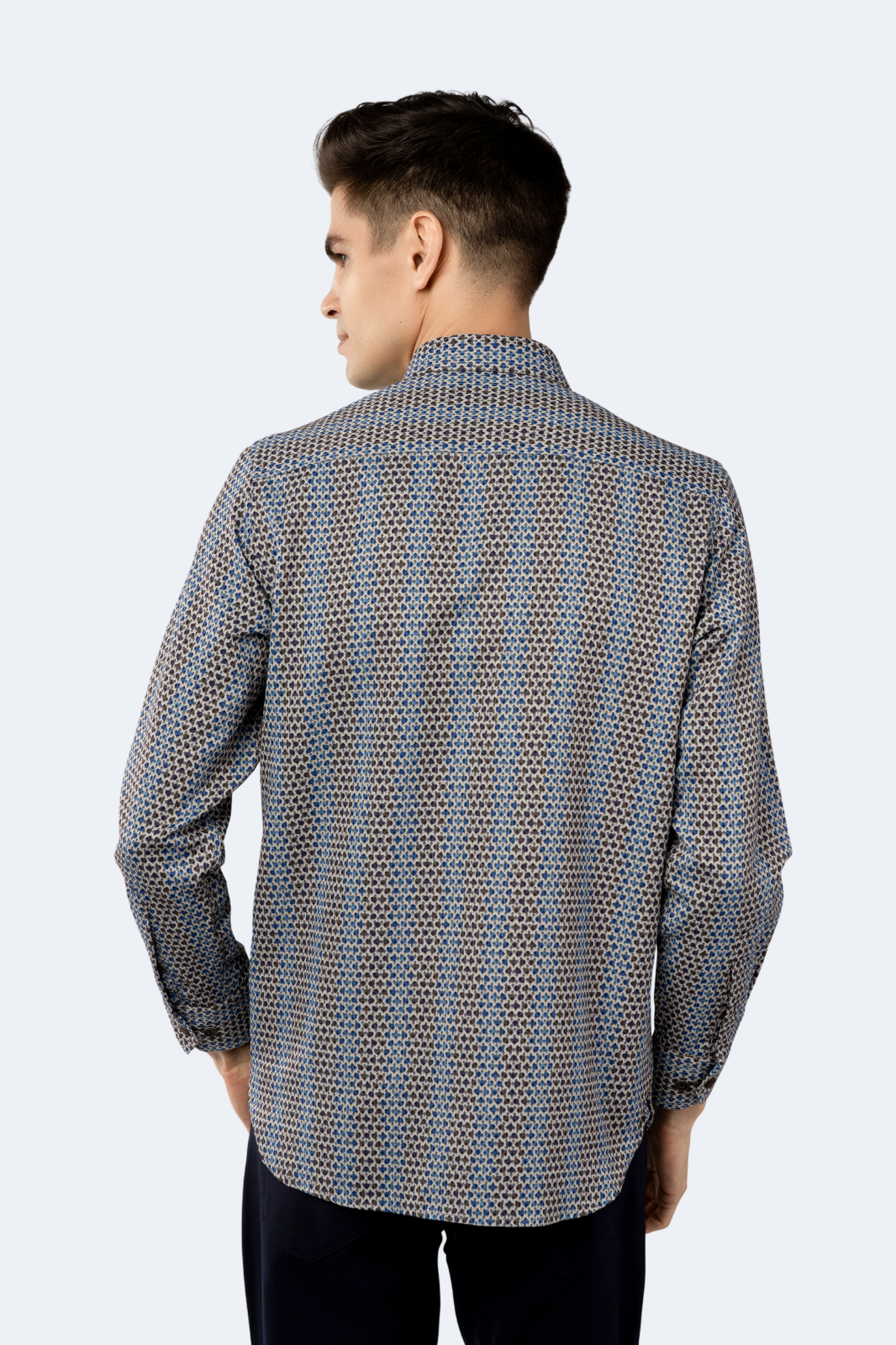 Man wearing a patterned shirt on a white background