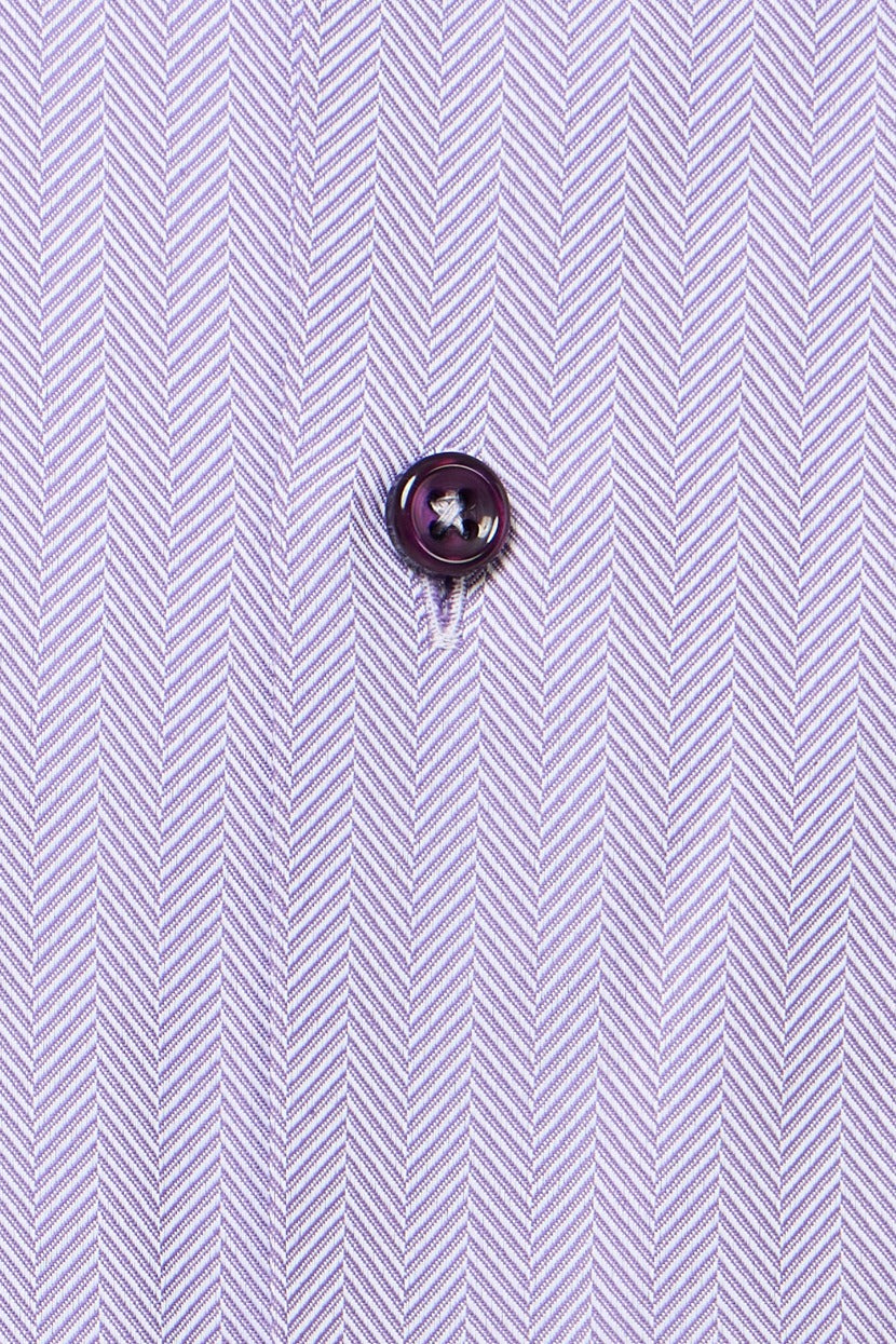 Close-up of a button on a shirt with a herringbone pattern